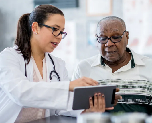 doctor and patient looking at a tablet together